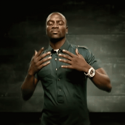 A Man Wearing A Watch Holds His Hands Over His Chest GIF