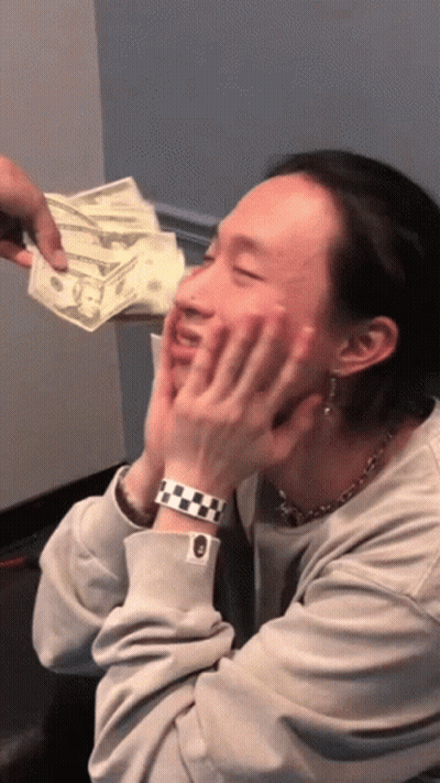 A Man Wearing A Watch Is Being Handed A Stack Of Money GIF