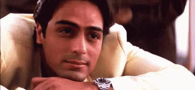 A Man Wearing A Watch Rests His Head On His Hand . GIF