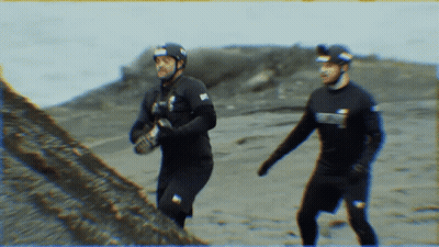 A Man Wearing A Wet Suit With The Word Scuba On It GIF