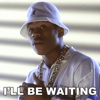 A Man Wearing A White Bucket Hat And A Gold Chain Says I 'Ll Be Waiting GIF