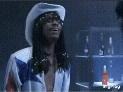 A Man Wearing A White Cowboy Hat And A Blue And White Shirt GIF