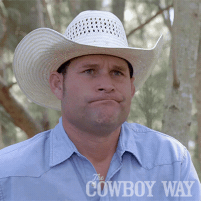 A Man Wearing A White Cowboy Hat And A Blue Shirt With The Cowboy Way Written On The Bottom GIF