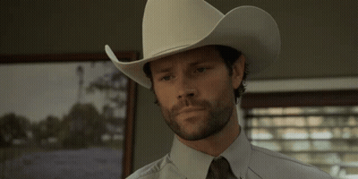 A Man Wearing A White Cowboy Hat And Tie GIF