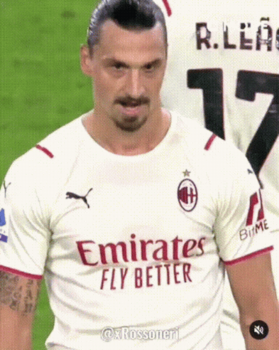 A Man Wearing A White Emirates Fly Better Shirt GIF