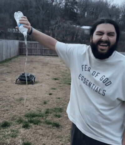 A Man Wearing A White Fear Of God Essentials Shirt GIF
