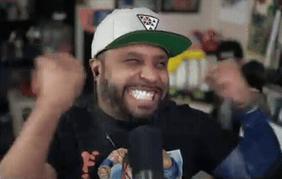 A Man Wearing A White Hat And A Black Shirt Is Making A Funny Face GIF