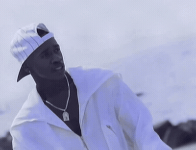 A Man Wearing A White Hat And A White Jacket Has A Pendant Around His Neck That Says Jesus GIF
