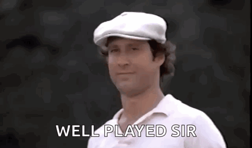 A Man Wearing A White Hat And A White Shirt Is Giving A Thumbs Up Sign . GIF