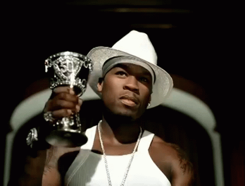 A Man Wearing A White Hat Is Holding A Silver Trophy GIF