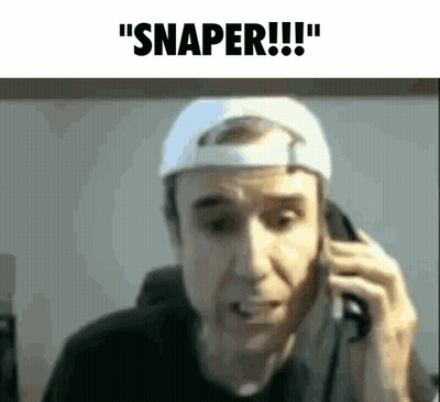 A Man Wearing A White Hat Is Talking On A Cell Phone And Says Snaper GIF