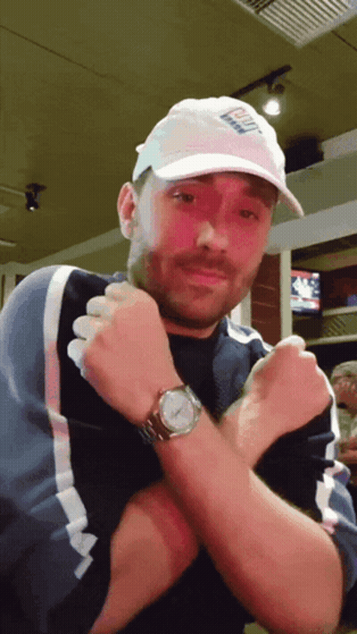 A Man Wearing A White Hat That Says ' Bud Light ' On It GIF