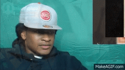 A Man Wearing A White Hat With A Chicago Cubs Logo On It . GIF