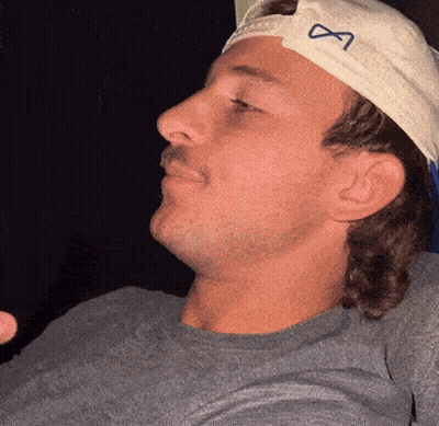 A Man Wearing A White Hat With An Infinity Symbol GIF