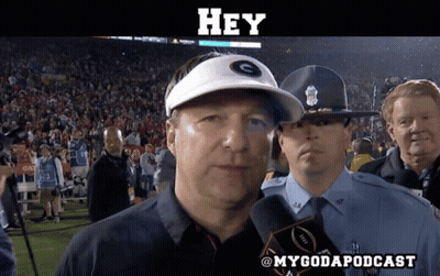 A Man Wearing A White Hat With The Letter G On It Talks Into A Microphone GIF