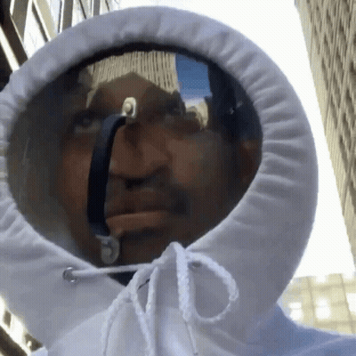 A Man Wearing A White Hoodie With A Reflection Of A Building In It GIF