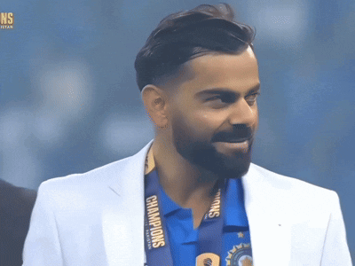 A Man Wearing A White Jacket And A Medal That Says Champions On It GIF