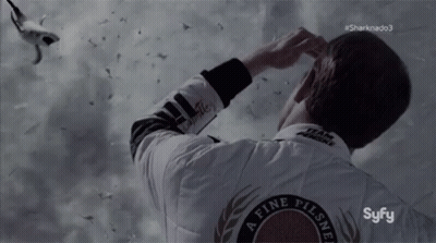A Man Wearing A White Jacket That Says ' A Fine Pilsner ' On The Back GIF