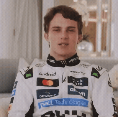 A Man Wearing A White Jacket With Logos For Dell Technologies And Monster Energy On It GIF