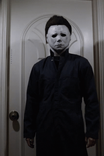 A Man Wearing A White Mask And A Black Jacket GIF
