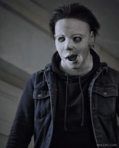 A Man Wearing A White Mask And A Black Jacket Has Muglife.com Written On The Bottom Right GIF