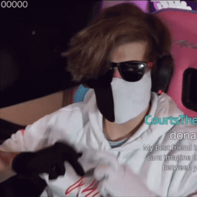 A Man Wearing A White Mask And Sunglasses Is Sitting In A Pink Chair . GIF