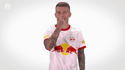 A Man Wearing A White Red Bull Jersey Making A Funny Face GIF