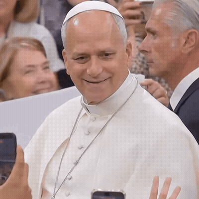 A Man Wearing A White Robe And A White Hat Is Smiling GIF