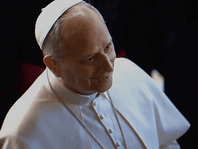 A Man Wearing A White Robe And A White Hat Is Smiling GIF