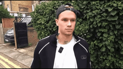 A Man Wearing A White Shirt And A Black Jacket Has A Tattoo On His Neck That Says " I Love You " GIF