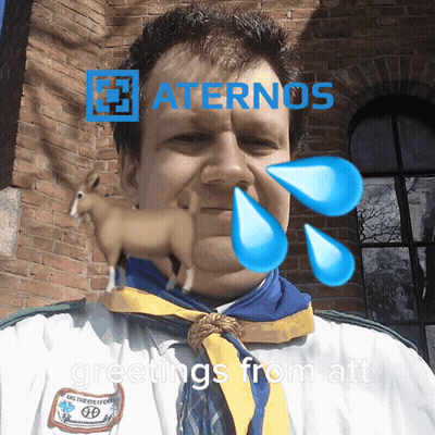 A Man Wearing A White Shirt And A Blue Scarf With Greetings From Att On The Bottom GIF