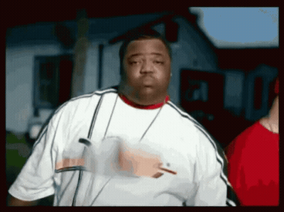 A Man Wearing A White Shirt And A Red Collar Is Standing In Front Of A House . GIF