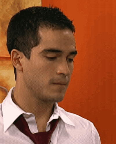 A Man Wearing A White Shirt And A Red Tie Looks Down GIF