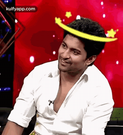 A Man Wearing A White Shirt And A Yellow Crown On His Head . GIF