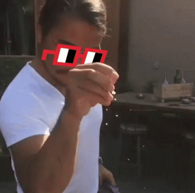 A Man Wearing A White Shirt And Red Sunglasses With The Letter H On The Lens GIF