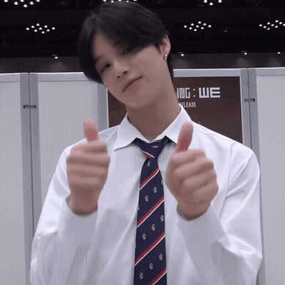 A Man Wearing A White Shirt And Tie Gives A Thumbs Up GIF