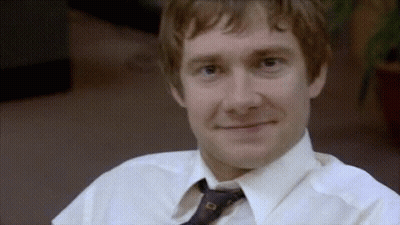 A Man Wearing A White Shirt And Tie Is Smiling . GIF