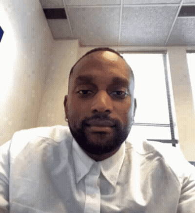 A Man Wearing A White Shirt And Tie Looks At The Camera GIF