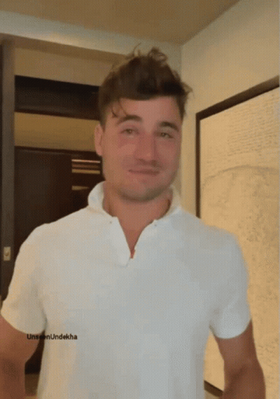 A Man Wearing A White Shirt Has The Word Unseen Underkha On The Bottom Of His Shirt GIF