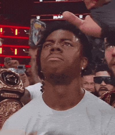 A Man Wearing A White Shirt Is Looking Up At The Sky GIF