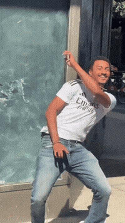 A Man Wearing A White Shirt That Says Emirates GIF