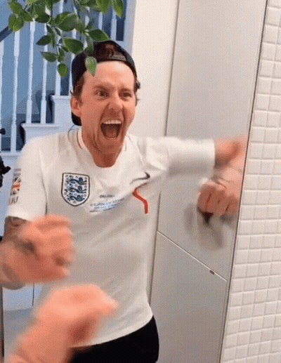 A Man Wearing A White Shirt That Says " England " On It GIF