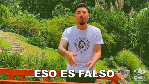 A Man Wearing A White Shirt That Says Eso Es Falso On It GIF