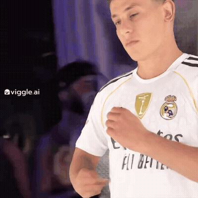 A Man Wearing A White Shirt That Says Fly Emirates On It GIF