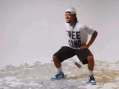 A Man Wearing A White Shirt That Says Free Dino Is Squatting In Front Of A Pile Of Money GIF