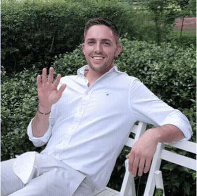 A Man Wearing A White Shirt That Says Gant On The Front GIF