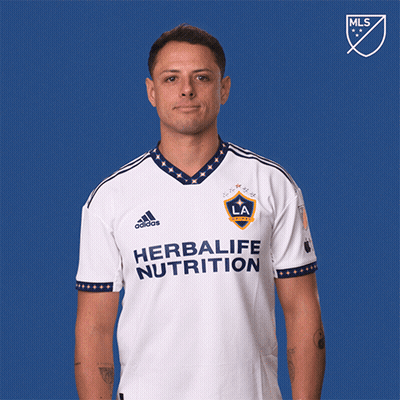 A Man Wearing A White Shirt That Says Herbalife Nutrition Is Pointing Up GIF