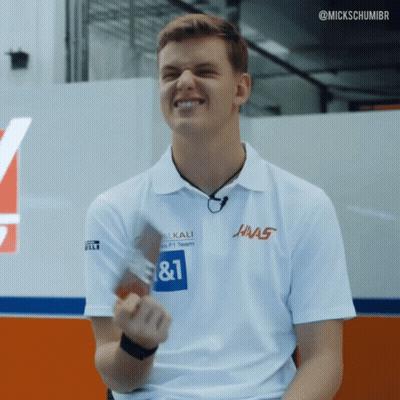 A Man Wearing A White Shirt That Says ' Hnas ' On It GIF