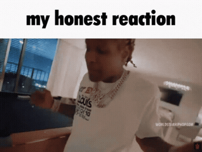 A Man Wearing A White Shirt That Says Louis Vuitton Is Standing In A Living Room . GIF