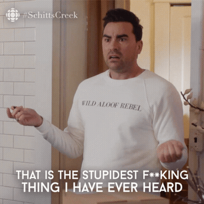 A Man Wearing A White Shirt That Says Wild Aloof Rebel On It GIF